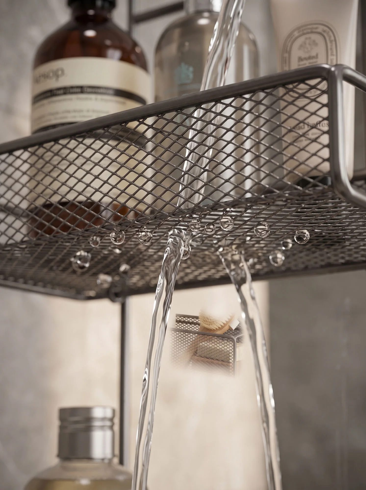 Water running straight through the mesh shelf and falling away beneath it
