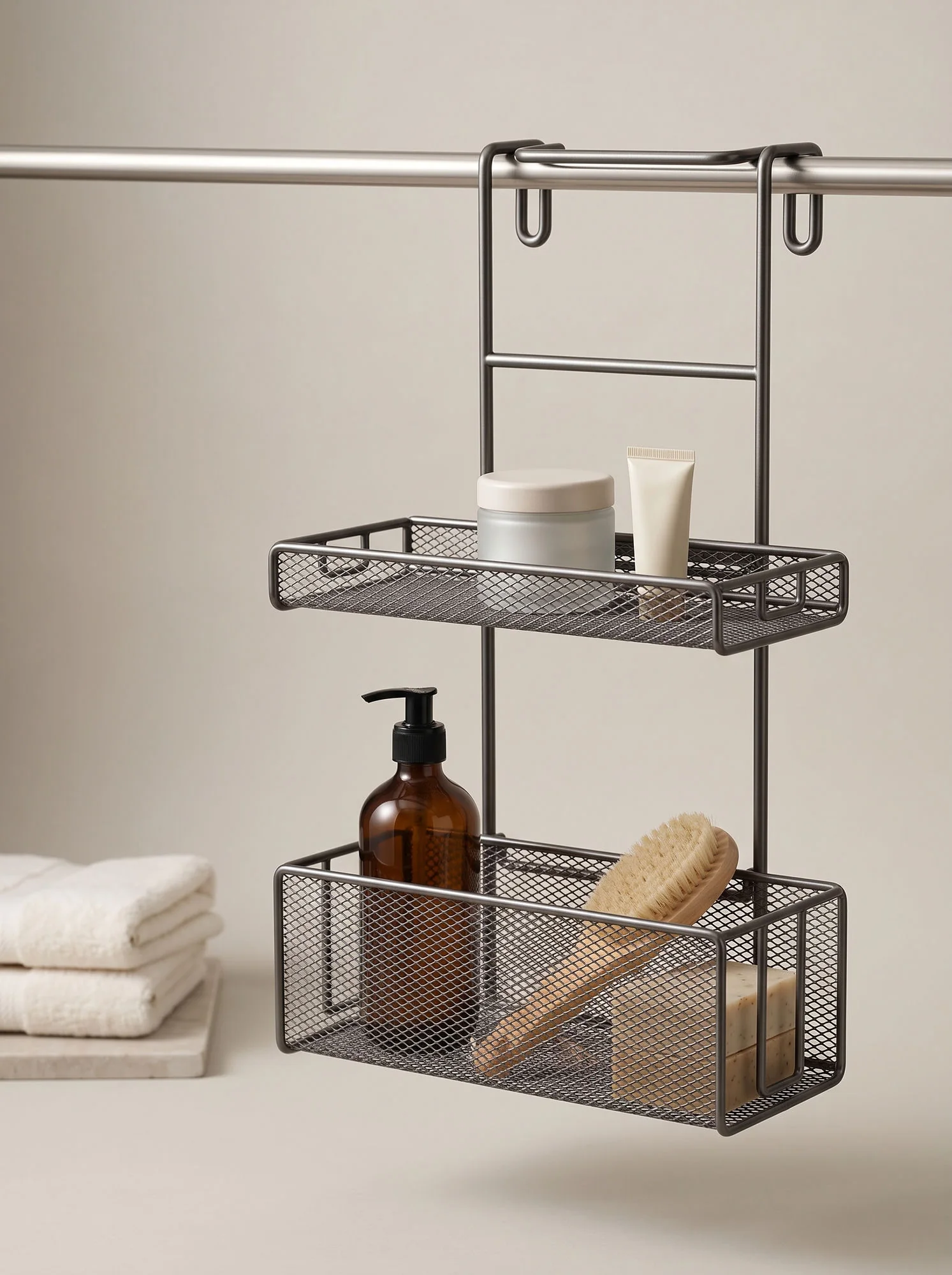 The caddy hanging from a rail beside folded towels